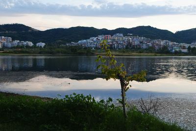 Scenic view of lake against cloudy sky