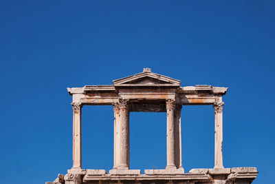 Low angle view of historical building against clear blue sky