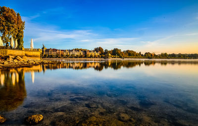 Scenic view of lake by building against sky