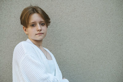 Teenage girl short red hair contrasts with serene expression in a portrait captures essence of youth