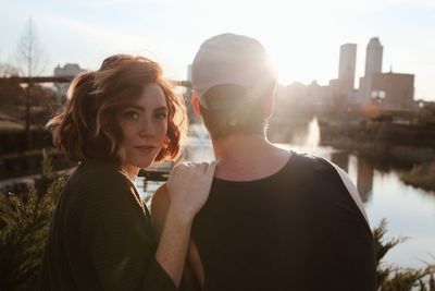 Couple kissing in city at sunset