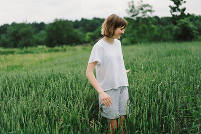 Teen girl in a field of green wheat. field of green wheat. 
