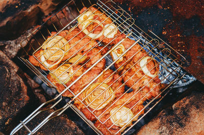 High angle view of meat on barbecue grill