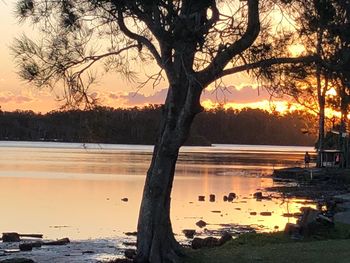 Scenic view of lake against orange sky