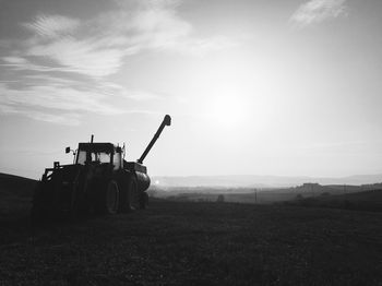 People working on field against sky