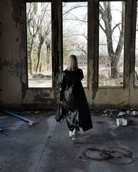 Rear view of woman in abandoned building