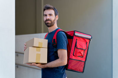 Portrait of man holding camera in box