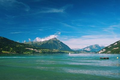 Scenic view of lake and mountains against sky