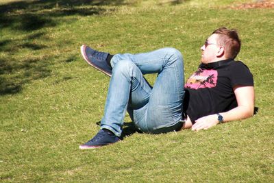 Woman sitting on grassy field