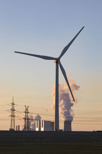 Germany, north rhine westphalia, neurath, wind turbine with lignite power station in background