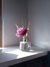 Pink flower in vase on table