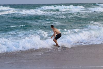 Full length of shirtless man in sea