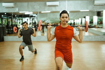 Portrait of woman exercising in gym