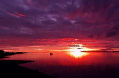 Scenic view of sea against orange sky