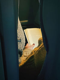 Midsection of person reading book