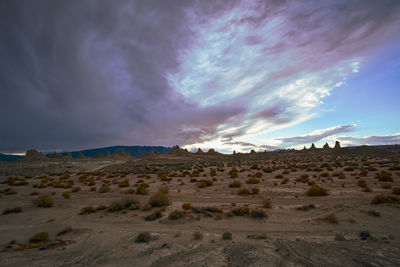 Clouds over vast desert landscape with distant trona pinnacle rock formations