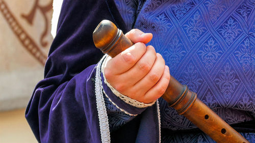 Midsection of woman holding flute