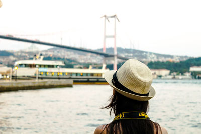 Rear view of woman looking at sea against sky