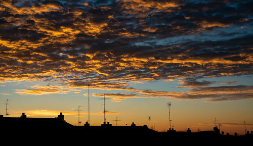 Low angle view of silhouette dramatic sky during sunset