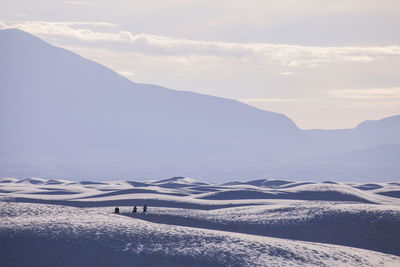 Scenic view of snow covered mountains against sky