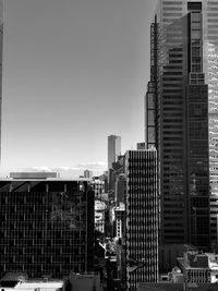 Modern buildings in city against clear sky