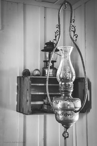 Close-up of electric lamp hanging on table at home