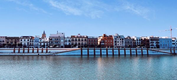 Buildings in city against blue sky triana sevilla