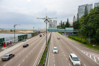 Traffic on road in city against sky