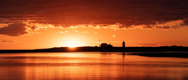 Scenic view of lake against sky during sunset