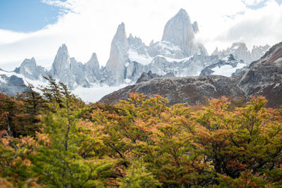 Scenic view of snowcapped mountains against sky in autumn