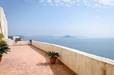 Scenic view of terrace by sea against sky