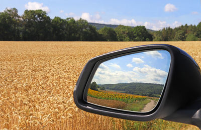 Reflection of sky on side-view mirror