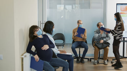 Rear view of people sitting at home