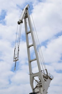 Low angle view of crane against sky