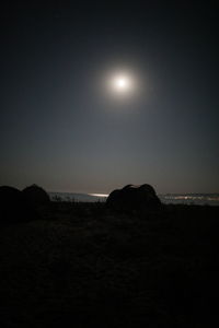 Scenic view of sea against clear sky at night