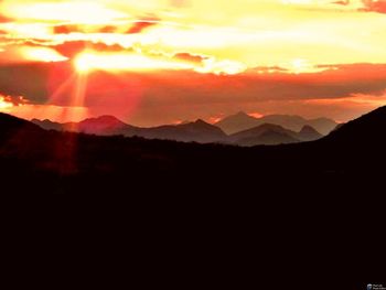 Scenic view of silhouette mountains against sky during sunset