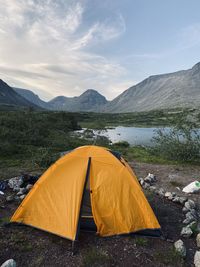 Tent in lake against sky