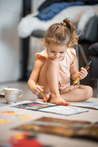 High angle view of girl drawing on table