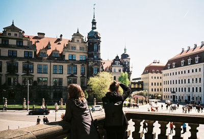 People in town against clear sky