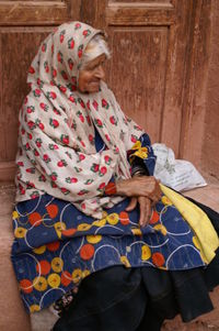 High angle view of woman sitting on floor