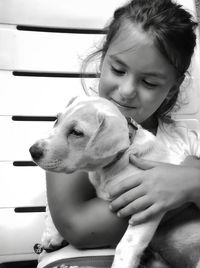 Close-up of cute girl holding dog