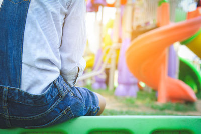 Mid section of boy on playground 