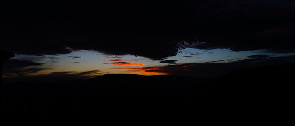 Low angle view of silhouette mountain against sky at sunset