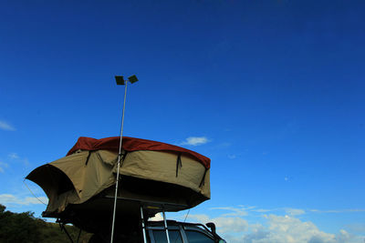 Low angle view of flag against blue sky