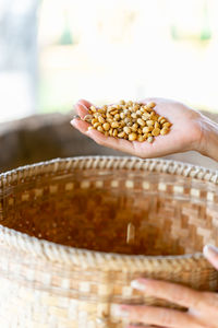 Close-up of hand holding bowl on table