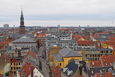 View of cityscape against cloudy sky