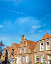 Low angle view of buildings against blue sky