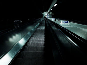Illuminated escalator at night