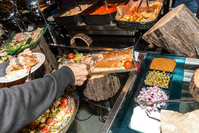 High angle view of person preparing food for sale at market