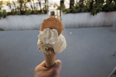 Close-up of hand holding ice cream